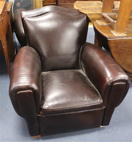 A pair of brown leather club chairs